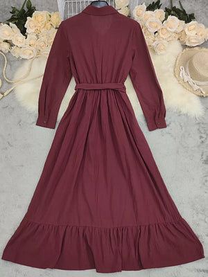 Red belted maternity maxi dress with ruffled hem and button front.