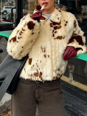 Cropped faux fur zip up jacket in beige with brown spots, featuring a collar and zip closure.