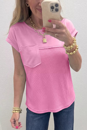 Pink waffled seam pocketed t-shirt with cuffed short sleeves and a curved hem.