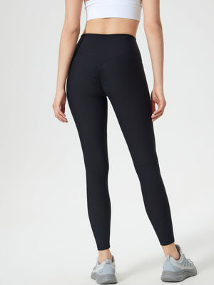 Black ribbed high-waist leggings with ruched detail on the back.