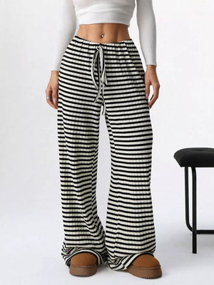 Striped ribbed wide-leg pants with drawstring waist in black and white.