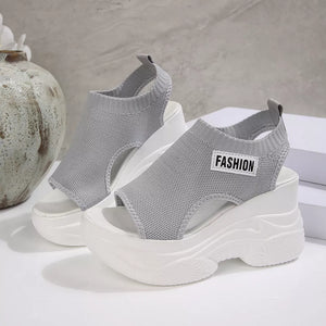 Fashion-forward gray open-toe wedge sandals with chunky white soles and "FASHION" label.