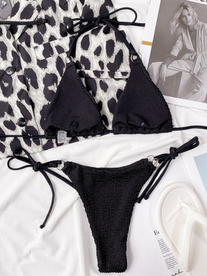 Black textured wrap bikini set with triangle cups and tie-side bottoms featuring ring details.