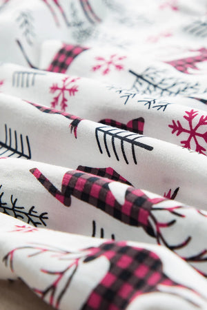 White pajama fabric with festive reindeer and snowflake print