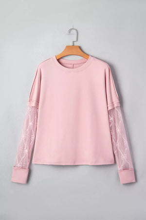 Pink maternity t-shirt with lace sleeves featuring bow details and crew neck.