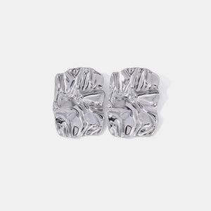 Textured silver sculptural stud earrings with an artistic, crinkled finish.