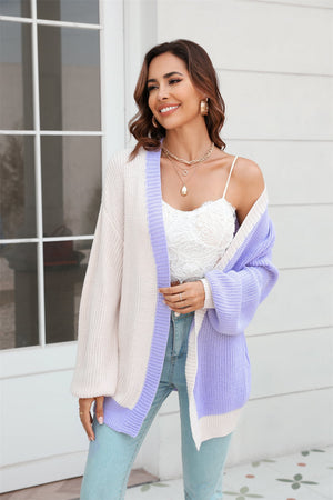 Colorblock knit cardigan with contrast trim in cream and lavender, featuring balloon sleeves.