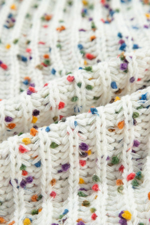 White confetti knit sweater with a textured ribbed pattern and colorful flecks.