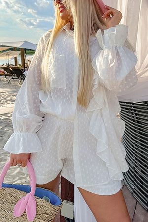 White textured ruffle trim shirt set with ruffled cuffs and layered ruffles on the shorts.