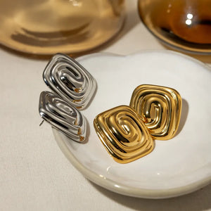 Sculpted swirl square earrings in gold and silver, featuring a contemporary, chic design.