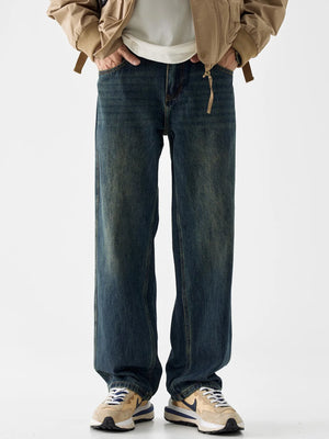 Loose fit blue cotton denim jeans with vintage wash and distressed details.