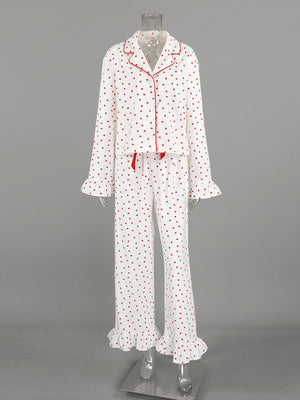 White cotton pajama set with red heart pattern, button front top, and ruffled cuffs and hem.