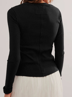 Black ribbed button-up second-skin top with long sleeves and a seam detail down the back.
