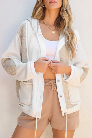 White waffle knit hoodie with quilted panels and adjustable drawstring hem.
