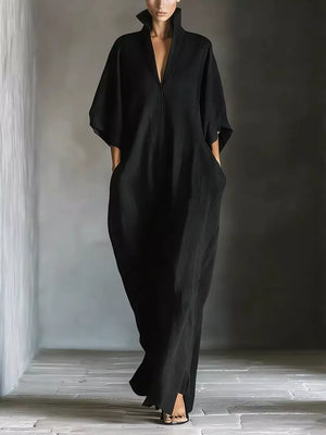 Black maxi dress with V-neck, short sleeves, and pockets.