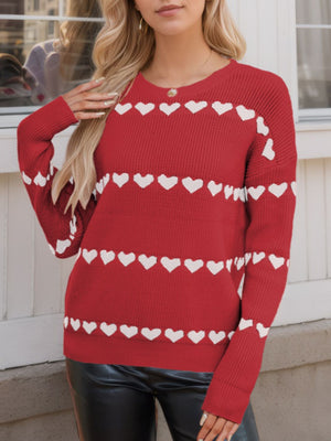 Scarlet knit sweater with white heart stripes, crew neck, long sleeves.