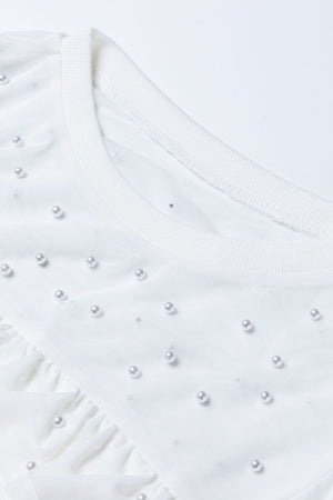 White mesh bodysuit with pearl embellishments and ruffled detail