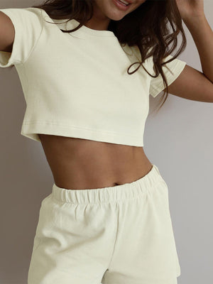 Cream waffle knit crop top with short sleeves and matching drawstring shorts.