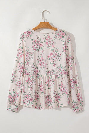 Floral peplum blouse with square neck and long sleeves.