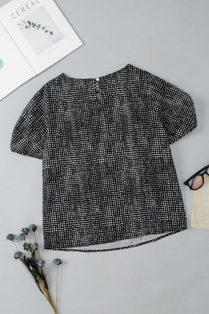 Black micro-dot puff sleeve blouse with round neckline and back keyhole closure.