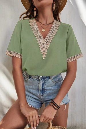 Light green short sleeve blouse with lace trim V-neck and cuffs