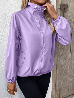 Lavender nylon bomber jacket with drawstring hem and zip front, styled casually.