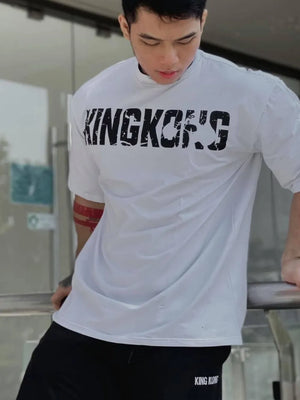 White oversized graphic tee with black King Kong's logo, short sleeves, and mock neck.