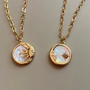 Gold sunburst medallion chain necklace and moon with star pendant on mother of pearl
