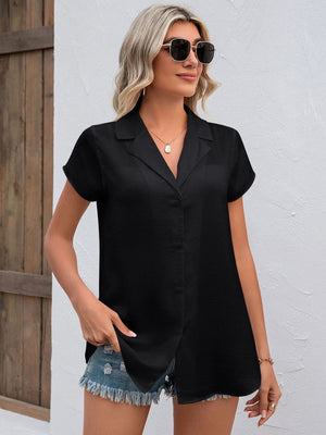 Black textured collared short sleeve shirt with button front and back pleat detail.
