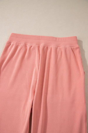 Pink corduroy lounge pants with relaxed fit and elastic waistband
