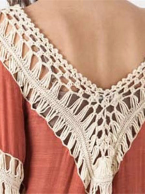 Orange long sleeve cardigan with crochet trim and fringe detail