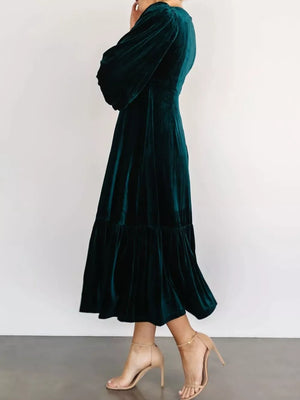 Opulent velvet midi dress in peacock blue with tiered skirt and balloon sleeves.