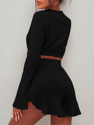 Black ribbed crop set with flared sleeves and ruffled hem shorts.