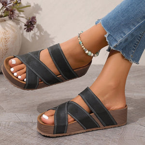 Black criss-cross platform sandals with open toe and chunky sole.