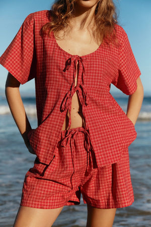 Open-front plaid cotton top with tie closure and matching shorts in deep red.