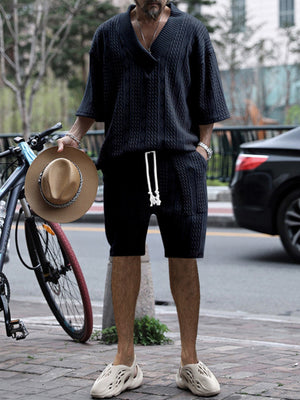 Men's navy blue cable-knit v-neck two-piece set with shorts and short-sleeve top.