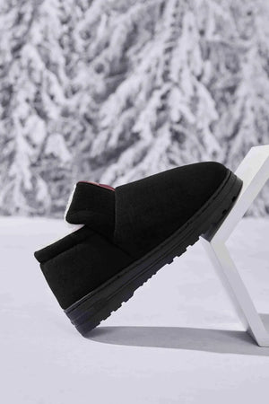 Black suede shearling-lined house booties with a thick sole.