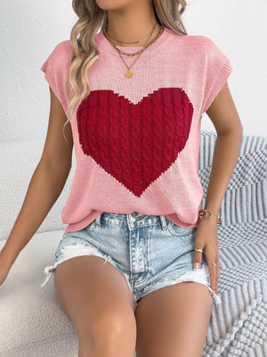 Blush pink cable knit sweater vest with a large red cable knit heart graphic.