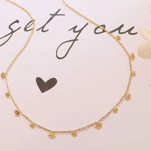 Gold dangling charm chain necklace with multiple eye charms.