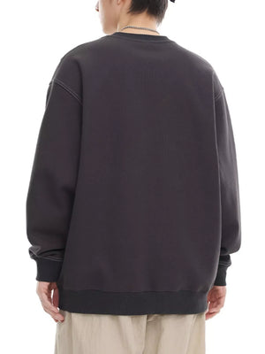 Oversized dark gray long-sleeve sweatshirt with crewneck and ribbed cuffs and hem.