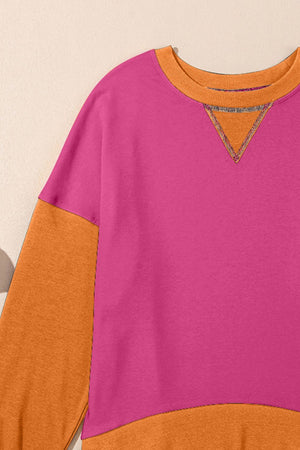 Chic Contrast Crewneck Sweatshirt in hot pink and tan with orange accents and a v-stitch detail.