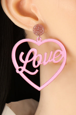 Pink glitter stud earrings with large heart cutouts spelling "Love