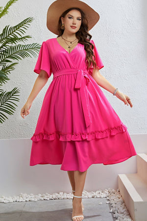 Hot pink wrap midi dress with flutter sleeves, belted waist, and tiered ruffled hem.
