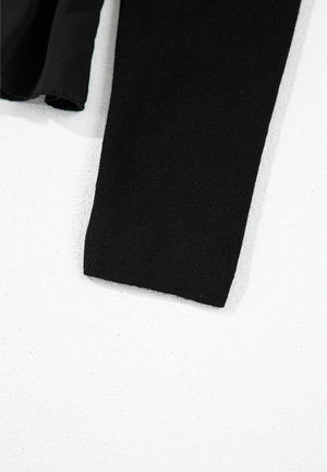Black ribbed bodice peplum top with a ruffled hem detail.