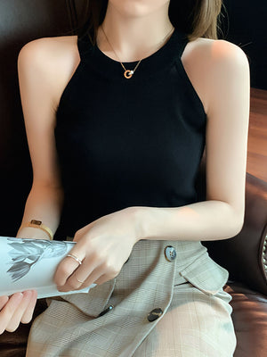 Black ribbed knit cami tank top with a mock neck and sleeveless design.