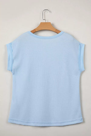 Light blue waffle knit t-shirt with cuffed sleeves and curved hem.
