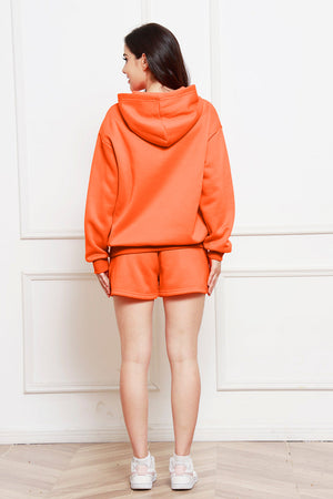 Orange oversized hoodie and bermuda shorts set with a relaxed fit.