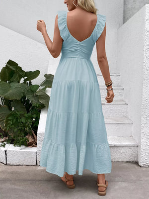 Light blue tiered maxi dress with flutter sleeves and V-neck, shown from the back.