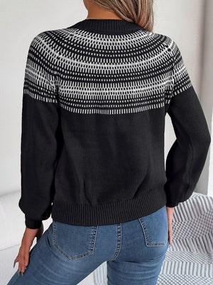 Black knit sweater with geometric yoke pattern and crew neck.