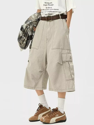 Khaki relaxed fit cargo cropped sweatpants with multiple pockets and contrast stitching.